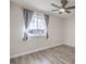 This bedroom has wood floors, a ceiling fan, and a window at 5200 Longridge Ave, Las Vegas, NV 89146