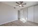 Bedroom with ceiling fan, closet, and light-colored wood flooring at 5200 Longridge Ave, Las Vegas, NV 89146