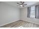 Bedroom with wood-look flooring, ceiling fan, and natural light from the window at 5200 Longridge Ave, Las Vegas, NV 89146