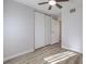 Bedroom featuring closet with sliding doors, neutral paint, and wood-look flooring at 5200 Longridge Ave, Las Vegas, NV 89146