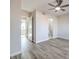 Spacious bedroom featuring a ceiling fan, wood-look flooring, and an ensuite bathroom at 5200 Longridge Ave, Las Vegas, NV 89146