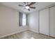 Cozy bedroom featuring window, wood-look flooring, ceiling fan, and closet at 5200 Longridge Ave, Las Vegas, NV 89146