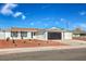 Charming single-story home featuring a well-manicured yard and a black garage door at 5200 Longridge Ave, Las Vegas, NV 89146