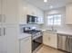 Well-lit kitchen showcasing stainless steel appliances, white cabinets, and a window above the sink at 5200 Longridge Ave, Las Vegas, NV 89146
