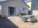 Backyard featuring a patio table, chairs, a grill and neutral rock landscaping at 5404 Walcott Dr, Las Vegas, NV 89118