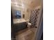 Bathroom with a white sink and cabinet, decorative shower curtain, and tile flooring at 5404 Walcott Dr, Las Vegas, NV 89118