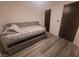 Well-lit bedroom with hardwood floors and a cozy sitting area at 5404 Walcott Dr, Las Vegas, NV 89118