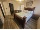 Comfortable bedroom with a decorative wooden bed frame and a cozy seating area at 5404 Walcott Dr, Las Vegas, NV 89118