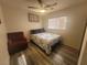 Relaxing bedroom featuring a full bed, comfortable chair, and wood-look floors at 5404 Walcott Dr, Las Vegas, NV 89118