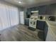 Functional kitchen with white appliances, stylish blue cabinets, and hard surface floors at 5404 Walcott Dr, Las Vegas, NV 89118