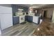 Bright kitchen with white appliances, blue cabinets, and hard surface floors open to dining area at 5404 Walcott Dr, Las Vegas, NV 89118