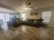 Spacious living room with wood-look floors, ceiling fan, and comfortable seating at 5404 Walcott Dr, Las Vegas, NV 89118