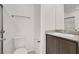 Clean bathroom featuring a single vanity with a granite countertop, a toilet, and modern fixtures for a sleek look at 5609 Steampunk St, Las Vegas, NV 89118