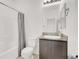 Bathroom with granite-topped vanity, toilet, and combination bathtub and shower with gray shower curtain at 5609 Steampunk St, Las Vegas, NV 89118