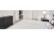 Spacious bedroom with ample storage, featuring a dresser, walk-in closet, and an attached bathroom for convenience at 5609 Steampunk St, Las Vegas, NV 89118