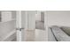 Bright hallway with white doors, tiled floors, and a peek into a carpeted bedroom and organized linen closet at 5609 Steampunk St, Las Vegas, NV 89118