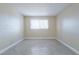 Cozy bedroom featuring tile flooring, neutral walls, and a bright window at 605 S Royal Crest Cir # 20, Las Vegas, NV 89169