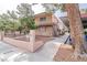 Exterior view of the apartment building featuring a tidy sidewalk, stairway, and mature trees at 605 S Royal Crest Cir # 20, Las Vegas, NV 89169