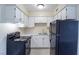 Functional kitchen features clean, white cabinets and classic black appliances at 605 S Royal Crest Cir # 20, Las Vegas, NV 89169