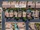 Aerial view showcases neighborhood homes, palm trees, solar panels, and community swimming pools at 6148 Whitelion Walk St, Las Vegas, NV 89148