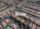 Aerial view shows a community with homes, pools, landscaping and the address 6148 Whitelion Walk at 6148 Whitelion Walk St, Las Vegas, NV 89148
