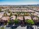 An aerial view of a residential community with well-maintained homes and desert landscaping at 6148 Whitelion Walk St, Las Vegas, NV 89148