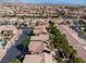 An aerial view captures a residential community featuring well-kept homes and palm-lined streets at 6148 Whitelion Walk St, Las Vegas, NV 89148