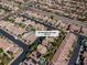 An aerial view of a desert community featuring lush landscaping, backyard pools, and modern homes at 6148 Whitelion Walk at 6148 Whitelion Walk St, Las Vegas, NV 89148
