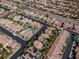 An aerial view of a desert community featuring lush landscaping, backyard pools, and modern homes at 6148 Whitelion Walk St, Las Vegas, NV 89148