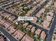 A high-angle aerial view shows homes in a desert community, many with private pools, at 6148 Whitelion Walk at 6148 Whitelion Walk St, Las Vegas, NV 89148