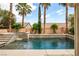 Beautiful backyard oasis with a sparkling pool, luxurious spa, and serene landscaping, perfect for unwinding in style at 6148 Whitelion Walk St, Las Vegas, NV 89148