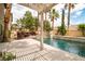 Lush backyard oasis with a sparkling pool, integrated spa, and stylish poolside pergola for shaded relaxation at 6148 Whitelion Walk St, Las Vegas, NV 89148