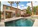 Inviting backyard featuring a sparkling pool, spa, built-in BBQ, and covered patio, perfect for outdoor entertaining at 6148 Whitelion Walk St, Las Vegas, NV 89148