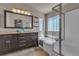 Bathroom boasts a soaking tub, walk-in shower, and double sink vanity with modern fixtures at 6148 Whitelion Walk St, Las Vegas, NV 89148