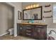 Bathroom features a double sink vanity with a large mirror and decorative shelving at 6148 Whitelion Walk St, Las Vegas, NV 89148