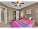 Bedroom boasts a ceiling fan, carpet flooring, and a walk-in closet at 6148 Whitelion Walk St, Las Vegas, NV 89148