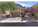 Charming two-story home boasts a well-manicured lawn, mature trees, and a two-car garage at 6148 Whitelion Walk St, Las Vegas, NV 89148