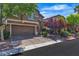 Beautiful two-story home features a two-car garage, lush trees, and a manicured lawn at 6148 Whitelion Walk St, Las Vegas, NV 89148