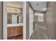 Hallway view showcasing a half bathroom and carpet flooring at 6148 Whitelion Walk St, Las Vegas, NV 89148