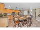 Bright eat-in kitchen features stainless appliances, granite counters, tile floors, and a large wooden island with seating at 6148 Whitelion Walk St, Las Vegas, NV 89148