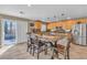 Charming kitchen boasting stainless appliances, granite counters, tile floors, and a large wooden island with seating at 6148 Whitelion Walk St, Las Vegas, NV 89148