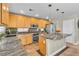 Stylish kitchen showcasing stainless appliances, granite counters, light wood cabinets and a kitchen island at 6148 Whitelion Walk St, Las Vegas, NV 89148