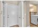 Mud room featuring front load washer and dryer, wire baskets, and overhead storage near the entryway at 6148 Whitelion Walk St, Las Vegas, NV 89148