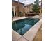 Tranquil backyard pool area with modern design elements and seamlessly integrated spa feature at 6148 Whitelion Walk St, Las Vegas, NV 89148
