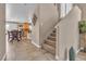 A bright staircase near a dining area creates an open feel, and easy access to the upper level at 6148 Whitelion Walk St, Las Vegas, NV 89148