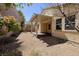 The backyard features a covered patio, perfect for outdoor dining and relaxation, complemented by desert-friendly landscaping at 677 Viale Machiavelli Ln, Henderson, NV 89011