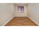 Simple bedroom with neutral walls, wood floor, and bright window at 677 Viale Machiavelli Ln, Henderson, NV 89011