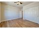 Bedroom featuring wood floors, a closet with sliding doors, and an open doorway at 677 Viale Machiavelli Ln, Henderson, NV 89011
