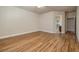 Bright bedroom featuring wood floors, a ceiling fan, and an open doorway to the walk-in closet at 677 Viale Machiavelli Ln, Henderson, NV 89011