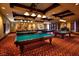Recreation room with multiple billiards tables under warm lighting, perfect for friendly competition at 677 Viale Machiavelli Ln, Henderson, NV 89011